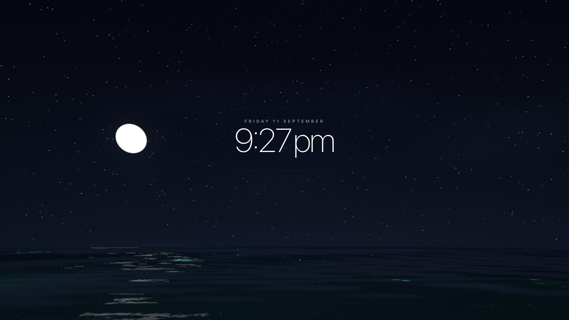 Ocean Clock screensaver at night, showing a moon over a dark, glowing ocean with the time 9:27pm